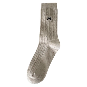 Beige mid-calf socks with colorful speckle yarn, vertical ribs and black bow embroidery