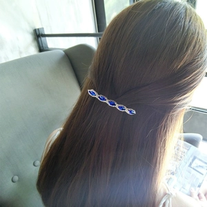 Vintage silver spring hair clip with blue rhinestones worn on hair back view