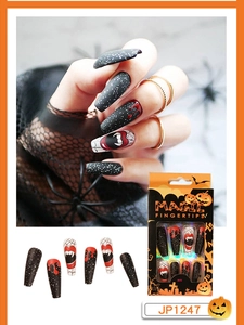 Detail of Halloween press on nails with matte black, blood drip design and spider web art