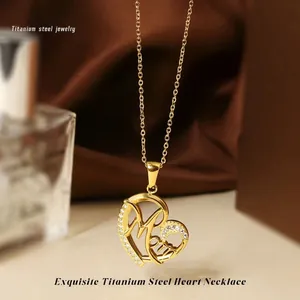 Macro shot of gold titanium heart pendant with Mom lettering and zircon stones