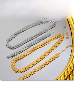 Detailed macro of gold and silver heart-shaped chunky chains with PVD electroplating finish