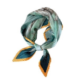 Pleated silk scarf with elephant and tropical plant patterns in teal and navy blue