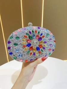 Detail of colorful gemstone sunburst pattern on silver rhinestone evening clutch bag