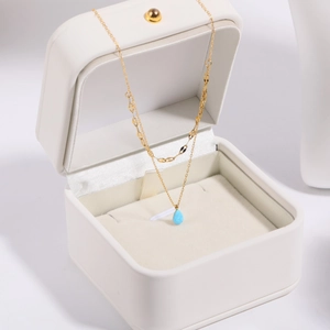 Double-layer 18K gold plated necklace with blue teardrop opal pendant in a white jewelry box