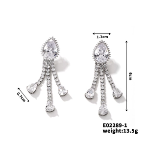 Detailed view of silver tassel earrings with teardrop zircons and size specifications