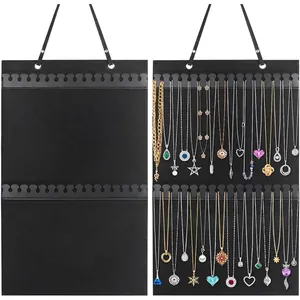 Wall-mounted black felt jewelry organizer with dual rows of hooks for necklaces