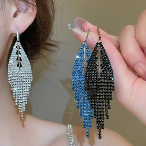Detailed view of silver long fringe earrings with geometric rhinestone leaf designs