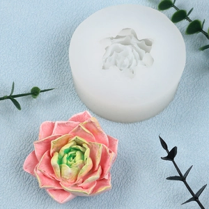 Detail view of white silicone mold with a pink succulent flower candle finished product