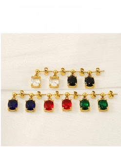 Macro detail of oval stud earrings set with colorful cubic zirconia in gold plating
