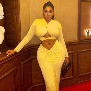 Detail of yellow two-piece knit set featuring hollow twist crop top and ruched maxi skirt