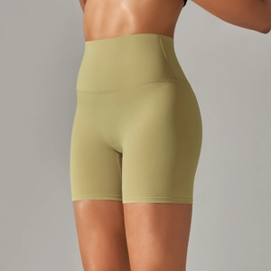 Detail of high-waisted olive green yoga shorts showing breathable fabric and supportive fit