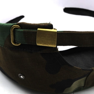 Detail of adjustable metal buckle and camouflage ripstop fabric on a military flat cap