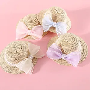 Miniature woven pet straw hats with elegant pearls and lace bows in various soft colors