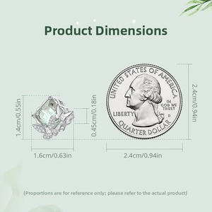 Size comparison of butterfly pendant with green gemstone next to a quarter coin