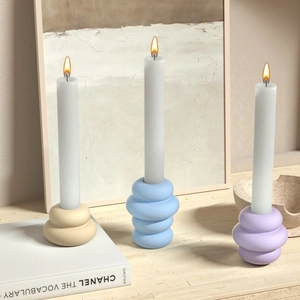 Modern ceramic ring candle holders in Morandi tones with matte finish on wooden surface