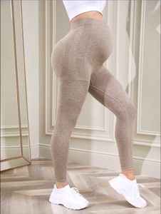 Detail of high-waist seamless maternity yoga leggings with breathable support texture