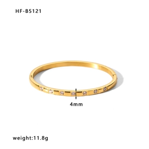 Detailed macro of 4mm wide 18k gold plated bangle with white zircon inlays and 11.8g weight
