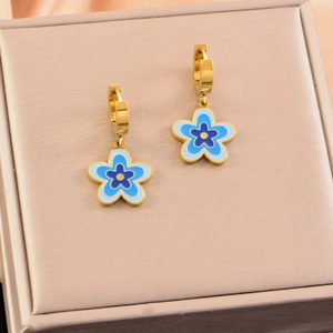 Pastel blue flower earrings with gold-plated base in a champagne jewelry box