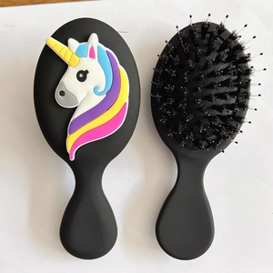 Detail of cute cartoon unicorn boar bristle paddle hairbrush set with rainbow bristles
