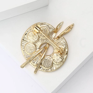 Macro shot of gold enamel palette brooch back view showing metal pin clasp structure