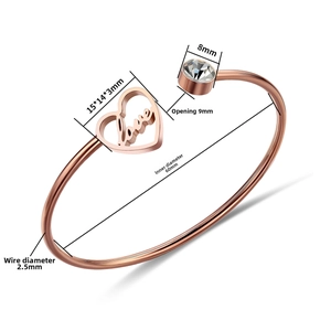 Detail view of rose gold steel heart bracelet with Love engraving and cubic zirconia