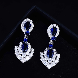 Elegant royal blue sapphire pendant earrings in silver setting on black luxury gift box