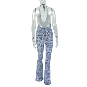 Detail of blue and purple leopard print backless halter jumpsuit on model