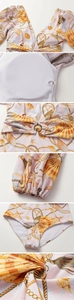 Detail of pink long-sleeved swimsuit with starfish print and metallic shell buckle