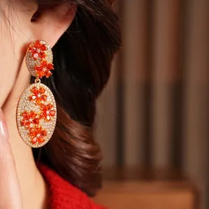 Vintage style gold oval drop earrings with orange zircon flowers and white stones