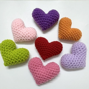 Handmade colorful crochet heart accessories in seven vibrant colors for DIY crafts