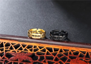 Macro detail of industrial razor blade rings in vintage gold and matte black finish