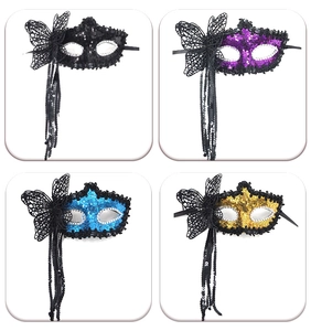 Detail of four colorful sequin masks with lace butterflies and tassels for masquerades