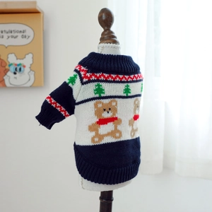Close-up of navy knit pet sweater with festive bear and Christmas tree patterns