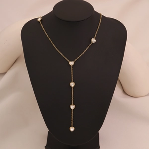Elegant gold heart stainless steel necklace with sparkling zircon stones on a black bust