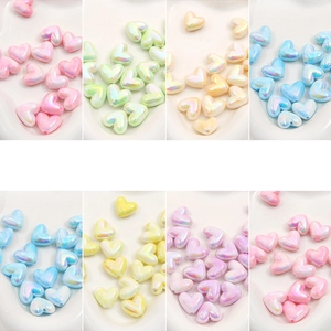 Close-up of colorful iridescent acrylic heart-shaped beads for DIY jewelry and phone chains