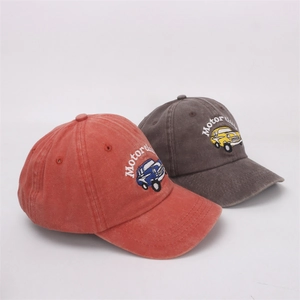 Close-up of vintage washed cotton baseball caps with car embroidery and motor club text