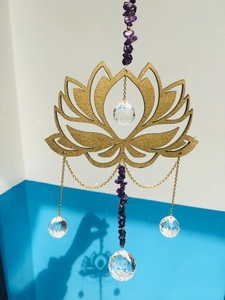 Detail of golden wooden lotus suncatcher with amethyst stones and crystal prisms