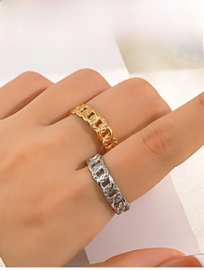 Close-up of gold and silver chain rings with cubic zirconia stones on model hand