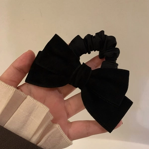 Elegant black velvet bow hair scrunchie with vintage French style for autumn and winter