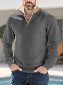 Detail of men's quarter-zip hoodie with contrast khaki elbow patches and textured fabric