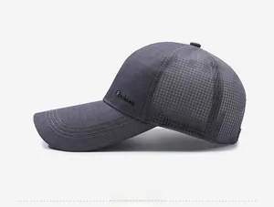 Detail view of breathable mesh fabric and fashion label on grey baseball cap