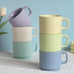 Detailed view of stackable striped ceramic mugs in six pastel macaron colors