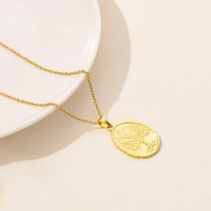 Detailed close-up of golden Tree of Life oval embossed pendant on a stainless steel chain