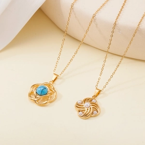 Detail of gold flower necklaces featuring blue gemstone and white pearl inlays
