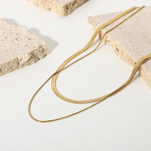 Double-layered golden herringbone snake chain necklace for women on minimalist stone