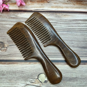 Sandalwood massage comb made of black gold wood with natural grain and smooth handle