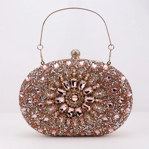 Detail of rose gold evening clutch with rhinestones and pink gemstone flower pattern