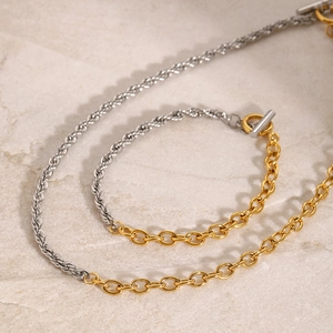 Close-up of dual-tone gold and silver chain necklace with a stylish T-bar clasp design