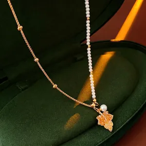 Gold plated maple leaf pendant necklace with pearls and amber crystal in a velvet box