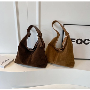 Detail of vintage suede PU leather hobo shoulder bags in dark brown and camel colors